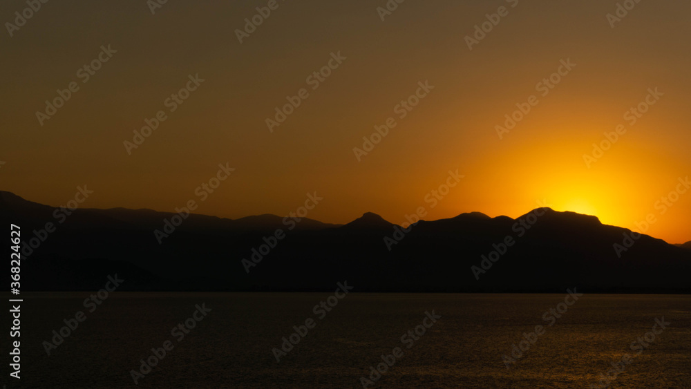 incredibly landscape of the setting sun against the backdrop of mountains