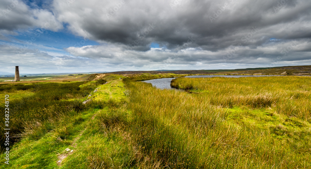 Fototapeta premium The Cupola chimney and adjacent reservoir. Grassington moor lead mines. Yorkshire Dales National Park