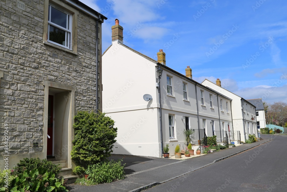 A residential street showing terrace houses in Charmouth,  Dorset, England, UK.