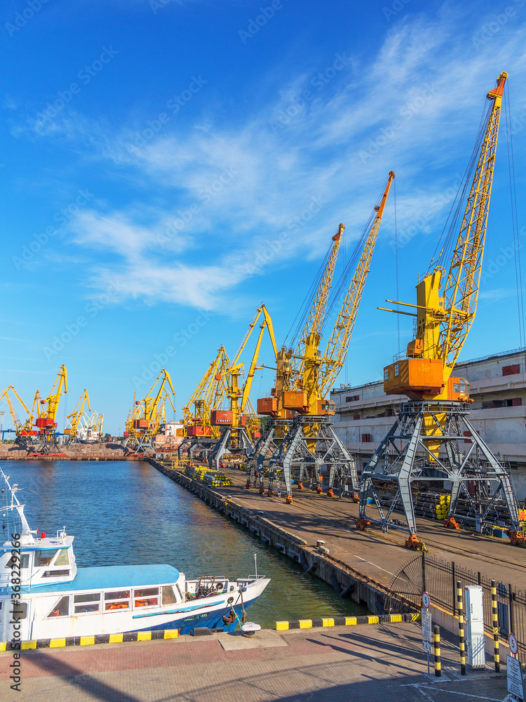 Odessa, Ukraine - July 6, 2016: Container cranes in cargo port terminal, cargo cranes without job in an empty harbor port. A crisis. Defaulted paralyzed entire economy of state, in the EU candidate