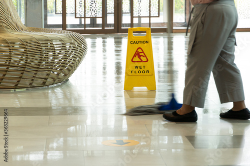 Mopping wet floor in lobby hotel. Background for caution wet floor.
