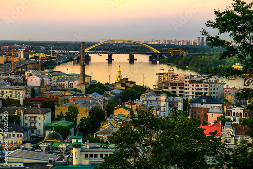 Evening view of the old Podil district of Kyiv and Dnipro River Dnieper with various bridges. Ukraine. July 2020
