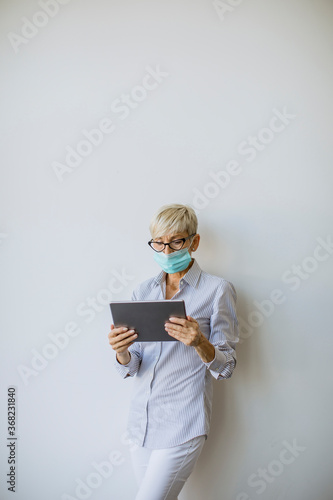 Mature businesswoman using ...