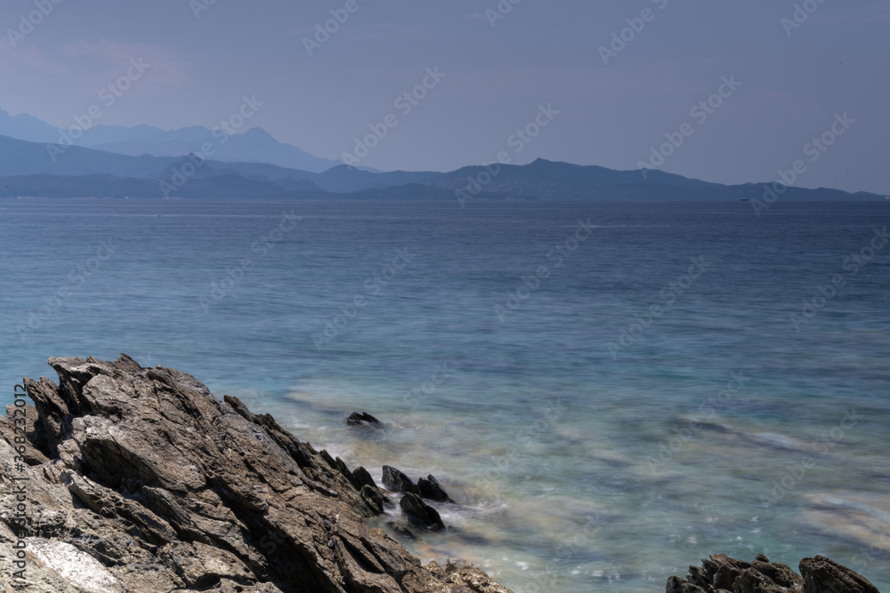 Long exposure of the sea and rocks on the coast of the Mediterranean Island of Corsica. Nonza. Long exposure of the sea and rocks on the coast of the Mediterranean Island of Corsica. Nonza.