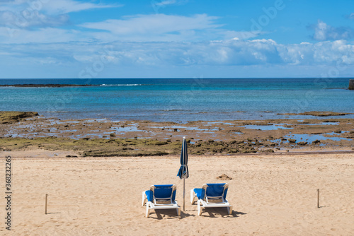 Beach chairs on the white sandy beach