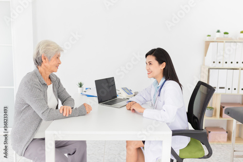 close up doctor, Asian doctor talk with old female patient about disease symptom in hospital, elderly health check up, happiness hospital