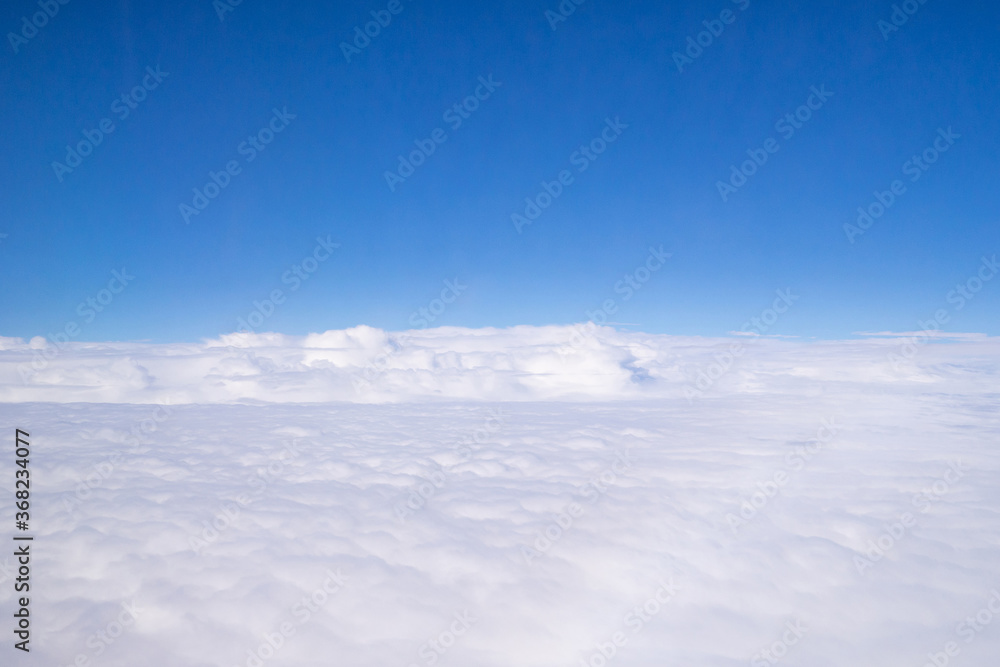 Aerial view of cloudscape seen through airplane window Aerial view of cloudscape seen through airplane window