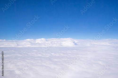 Aerial view of cloudscape seen through airplane window