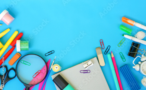 school stationery on blue background, copy space