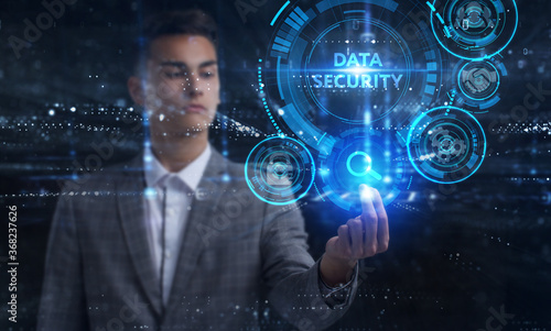 Business, Technology, Internet and network concept. Young businessman working on a virtual screen of the future and sees the inscription: Data security