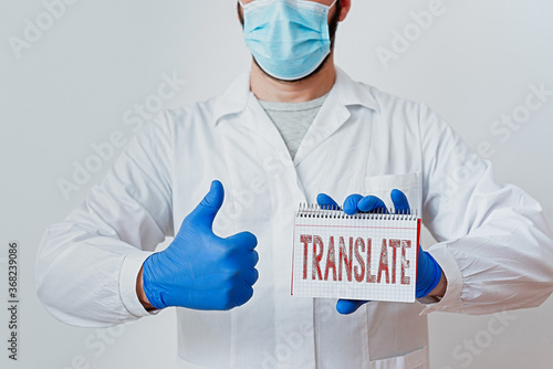 Conceptual hand writing showing Translate. Concept meaning bear, remove, or change from one place, state, form, or appearance Laboratory Technician Featuring Sticker Paper Smartphone photo