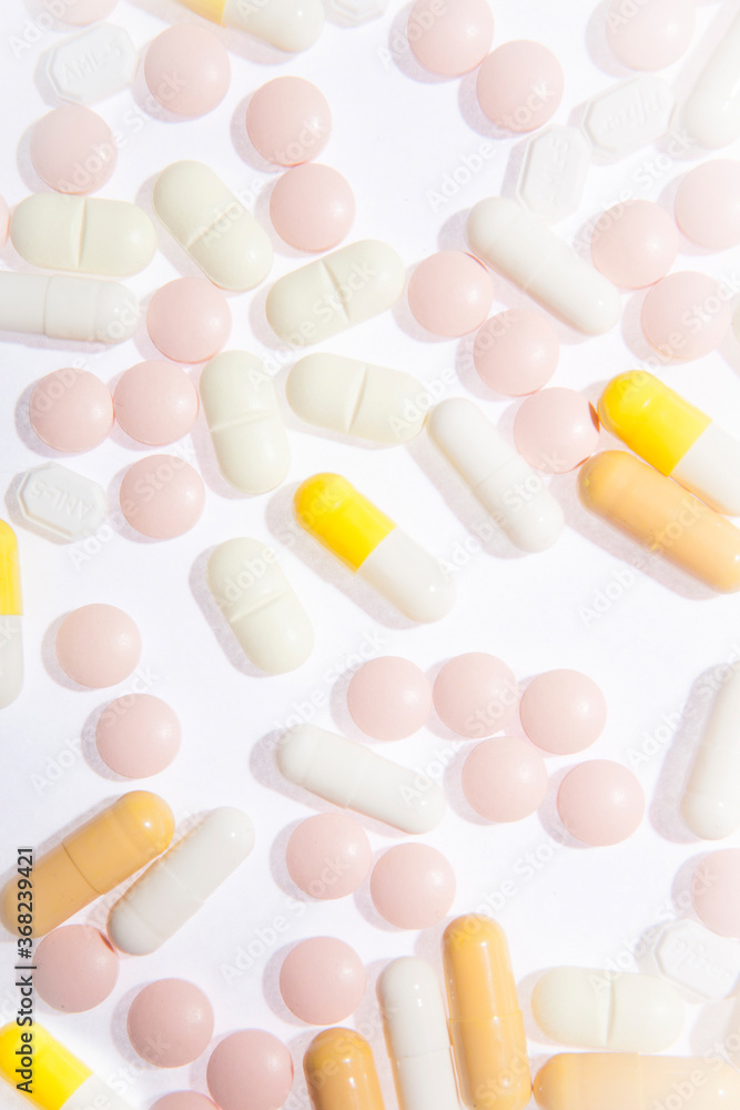Multicolored pills and capsules isolated on the white background. Medical theme Multicolored pills and capsules isolated on the white background. Medical theme