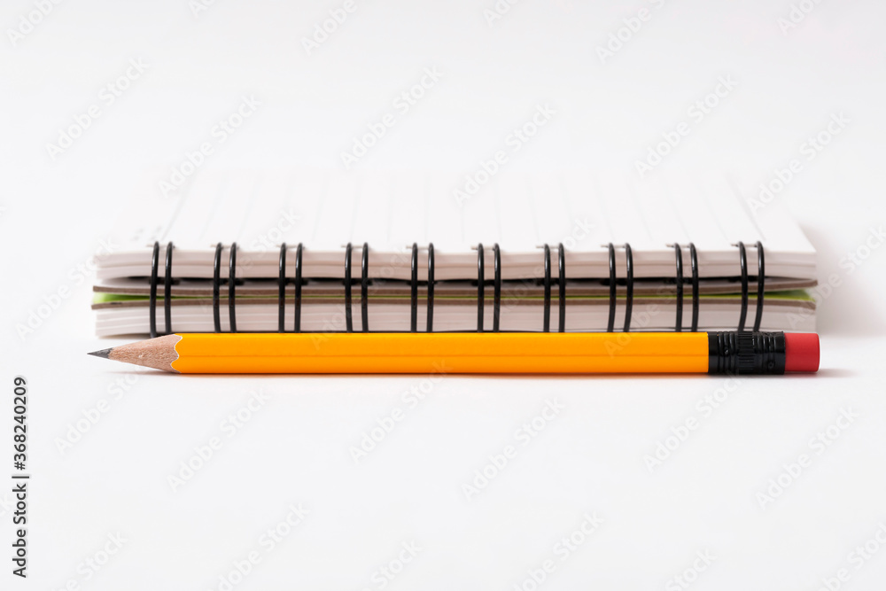 pencil and notebook on white background
pencil and notebook on white background