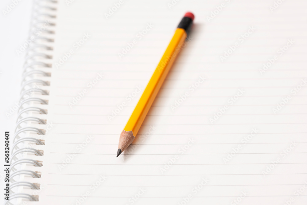 pencil and notebook on white background
pencil and notebook on white background