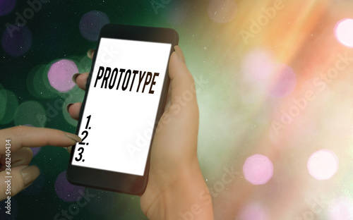 Conceptual hand writing showing Prototype. Concept meaning first and usually functional form of a new type or design Modern gadgets white screen under colorful bokeh background