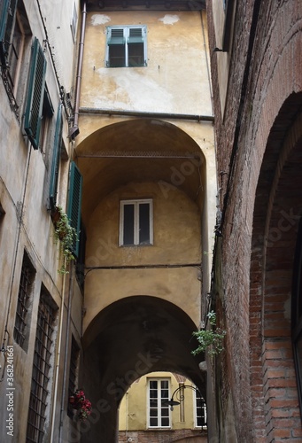 Fototapeta Naklejka Na Ścianę i Meble -  The atmospheric narrow street with the buildings in Tuscany Italy