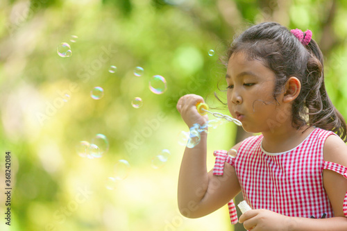 beautiful Kids blowing bubble outdoor happy lifestyle