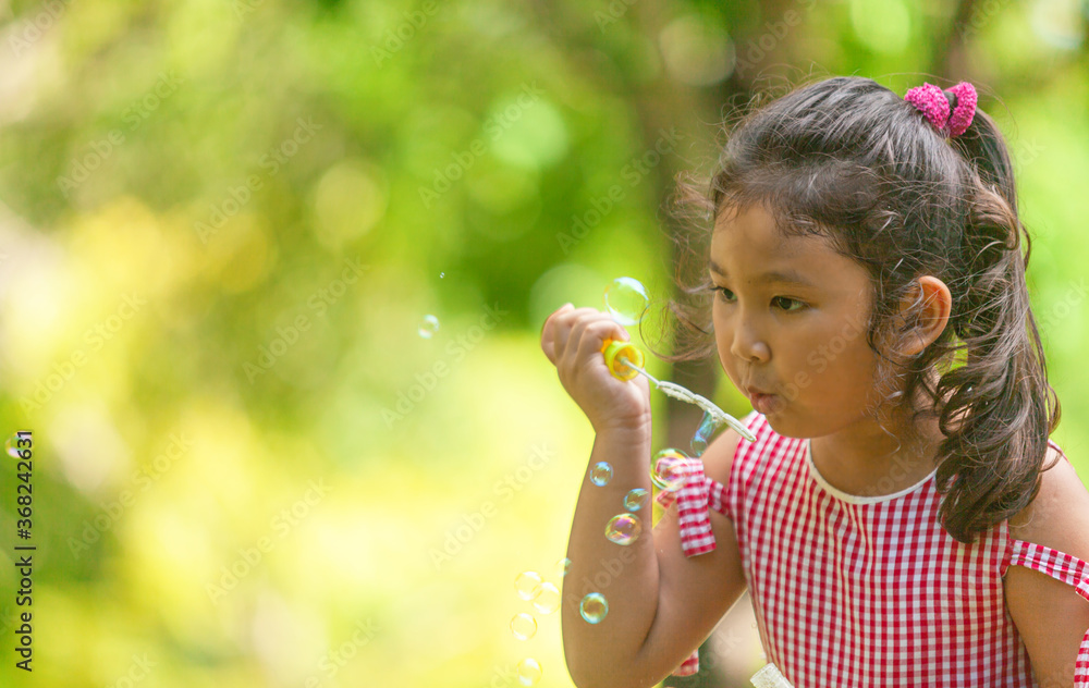 beautiful Kids blowing bubble outdoor happy lifestyle beautiful Kids blowing bubble outdoor happy lifestyle