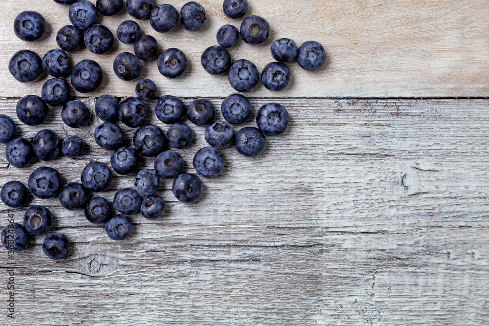 Blueberries on a white wooden background. Concept for healthy eating. Antioxidant organic superfood. Blueberries on a white wooden background. Concept for healthy eating. Antioxidant organic superfood.