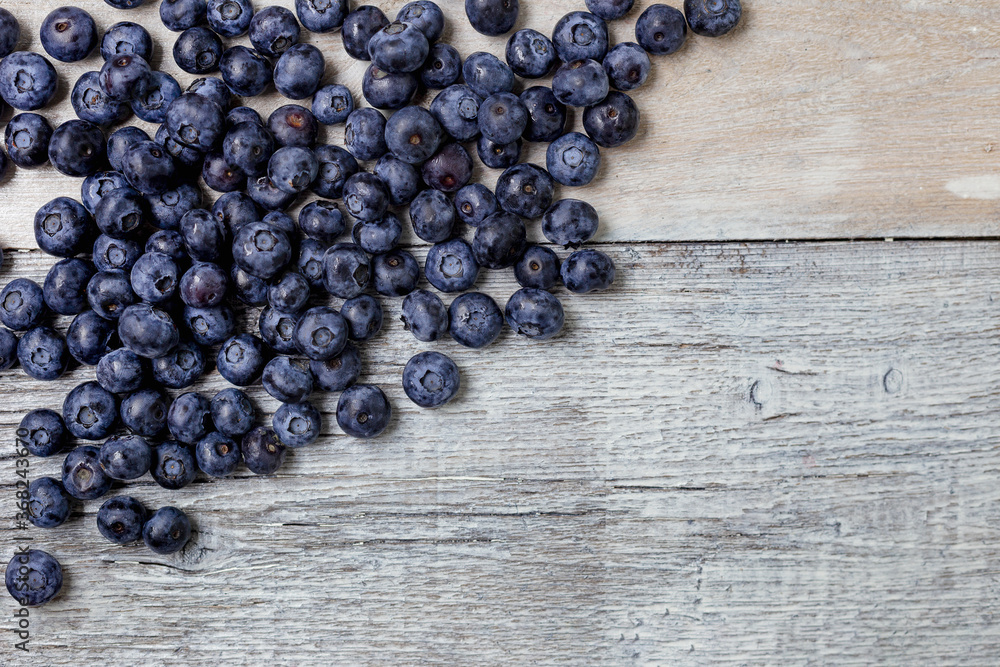 Blueberries on a white wooden background. Concept for healthy eating. Antioxidant organic superfood. Blueberries on a white wooden background. Concept for healthy eating. Antioxidant organic superfood.