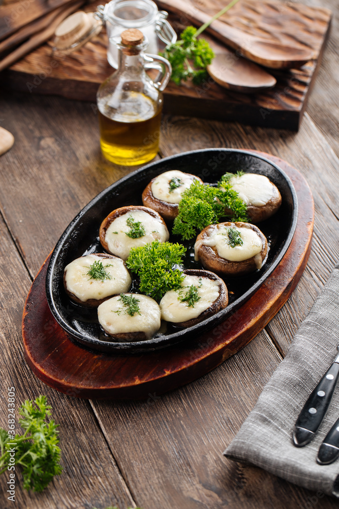 Baked stuffed champignon hats in a pan 