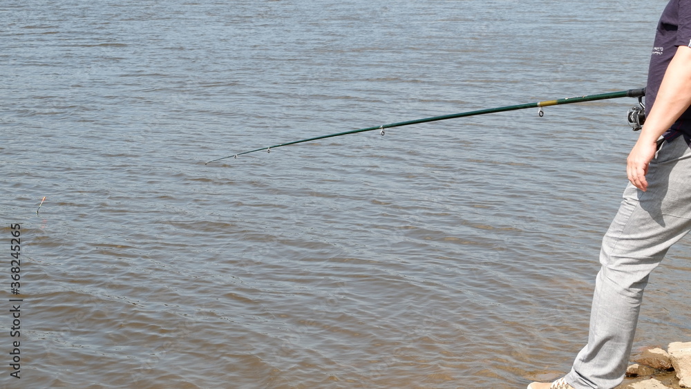 man fishing on the river