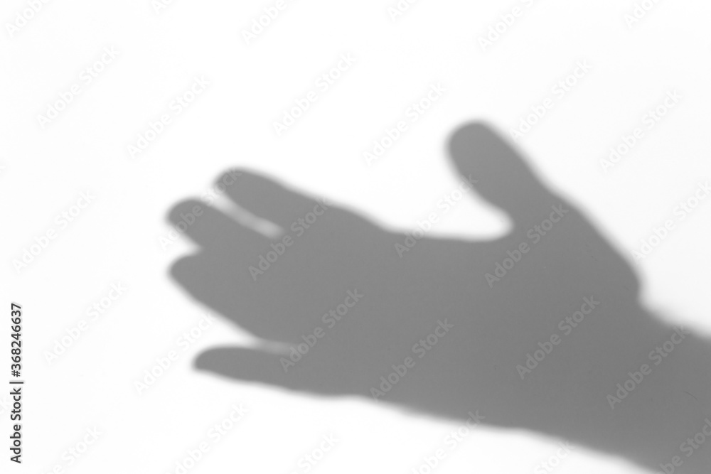 Shadow overlay effect for photo. Shadows from hand palms on white light wall in sunlight.