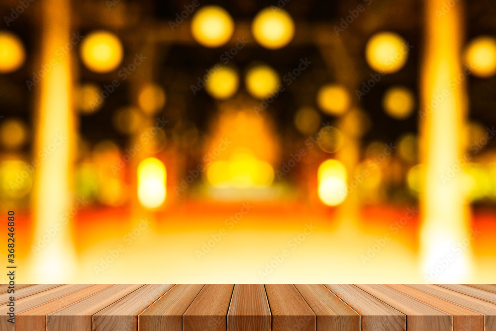 Empty wooden table on top blurred art temple hall shinening products or design for background