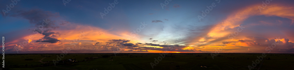 Panorama Top view Aerial photo from flying drone over village in Thailand.Top view beautiful Sunset.Sunrise with cloud rainy storm.