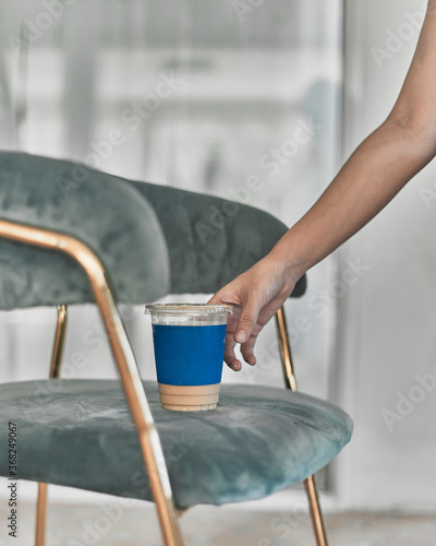 Woman holding iced coffee.