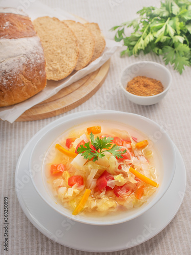 Cabbage soup, bread, parsley and spice on the table