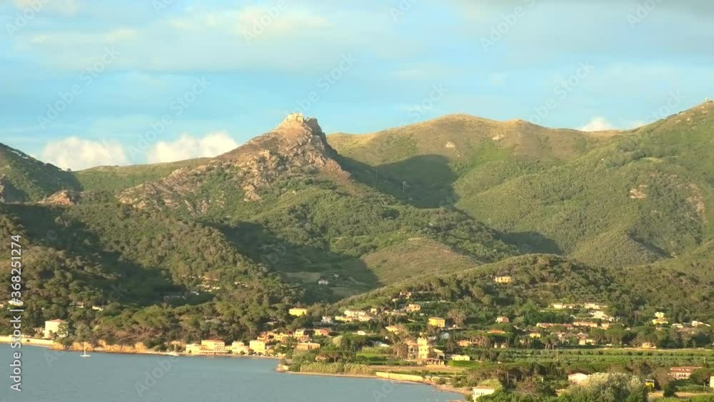 Iconic view of Volterraio Castle on rock at 394 m. Fortress of Volterraio, symbol of Elba Island, dominates Portoferraio Gulf. Panoramic landscape with view from top of Elba mountain. Tuscany, Italy. Iconic view of Volterraio Castle on rock at 394 m. Fortress of Volterraio, symbol of Elba Island, dominates Portoferraio Gulf. Panoramic landscape with view from top of Elba mountain. Tuscany, Italy.