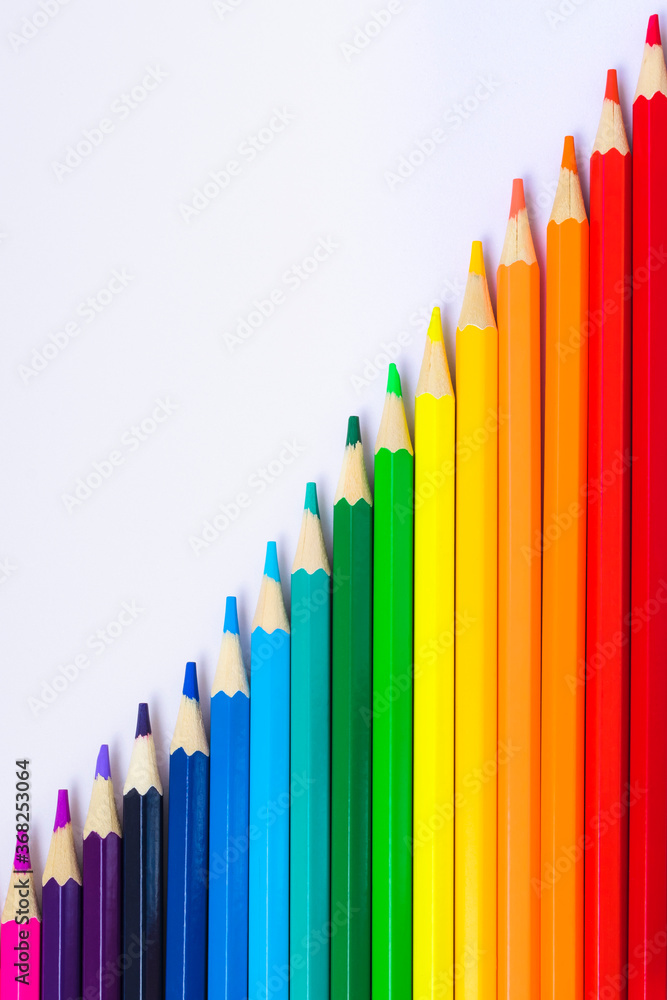 Colored pencils on a white background. View from above. Color palette from pencils. Children's creativity. School supplies. Office tools. Colored pencils on a white background. View from above. Color palette from pencils. Children's creativity. School supplies. Office tools.