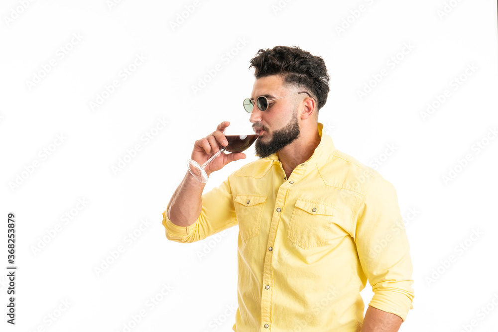 Sommelier, degustator with glass of red wine, winery, male winemaker. Beard man, bearded, sommelier tasting red wine. Man with a glass of wine in his hands Sommelier, degustator with glass of red wine, winery, male winemaker. Beard man, bearded, sommelier tasting red wine. Man with a glass of wine in his hands