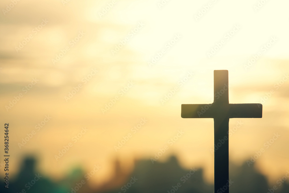 Silhouette cross against the sky At Sunset. Dramatic nature background. Crucifixion Of Jesus Christ. Religion concept.