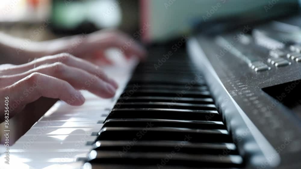 close-up of the hands of a pianist playing a song in the studio on a synthesizer close-up of the hands of a pianist playing a song in the studio on a synthesizer