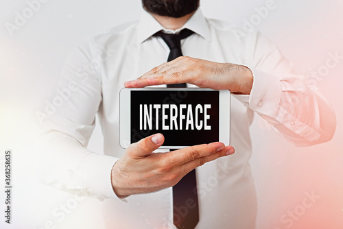 Writing note showing Interface. Business concept for the means by which interaction or communication is achieved Model displaying black screen modern smartphone mock-up photo