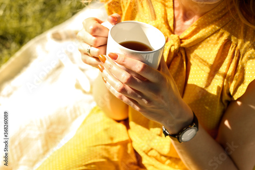 young woman drinking coffee in the park, relax in nature photo