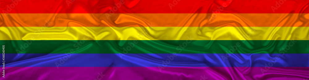 long panorama of LGBT rainbow flag on delicate silk with folds, the concept of historical, tourism, emigration, economics, politics, global world trade long panorama of LGBT rainbow flag on delicate silk with folds, the concept of historical, tourism, emigration, economics, politics, global world trade
