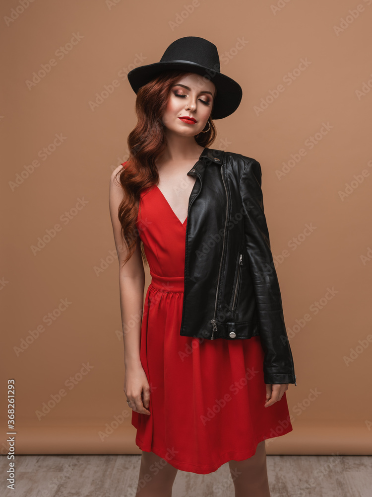 fashion model in red dress.Portrait of a beautiful girl in red dress.Studio shot of magnificent young woman in elegant clothes and classic hat. fashion model in red dress.Portrait of a beautiful girl in red dress.Studio shot of magnificent young woman in elegant clothes and classic hat.