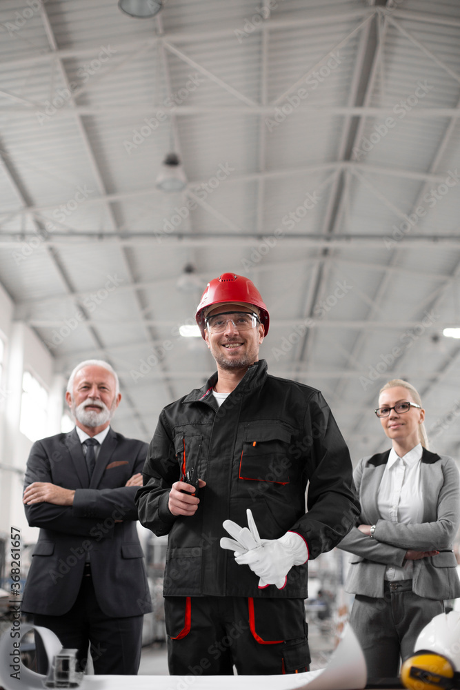 Colleagues working together. Arhitect and worker in factory.. Colleagues working together. Arhitect and worker in factory..