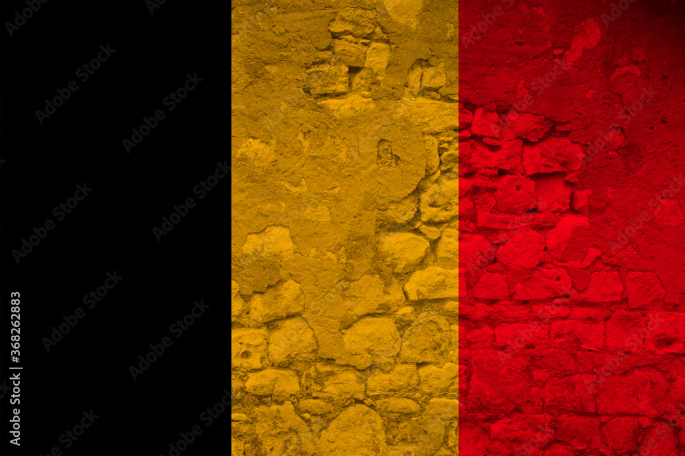 national flag of the state of Belgium on the texture of a rough, old stone wall with cracks, the concept of historical, tourism, emigration, economy, politics, global world trade national flag of the state of Belgium on the texture of a rough, old stone wall with cracks, the concept of historical, tourism, emigration, economy, politics, global world trade