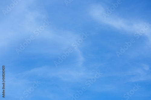 Blue sky background with tiny clouds.