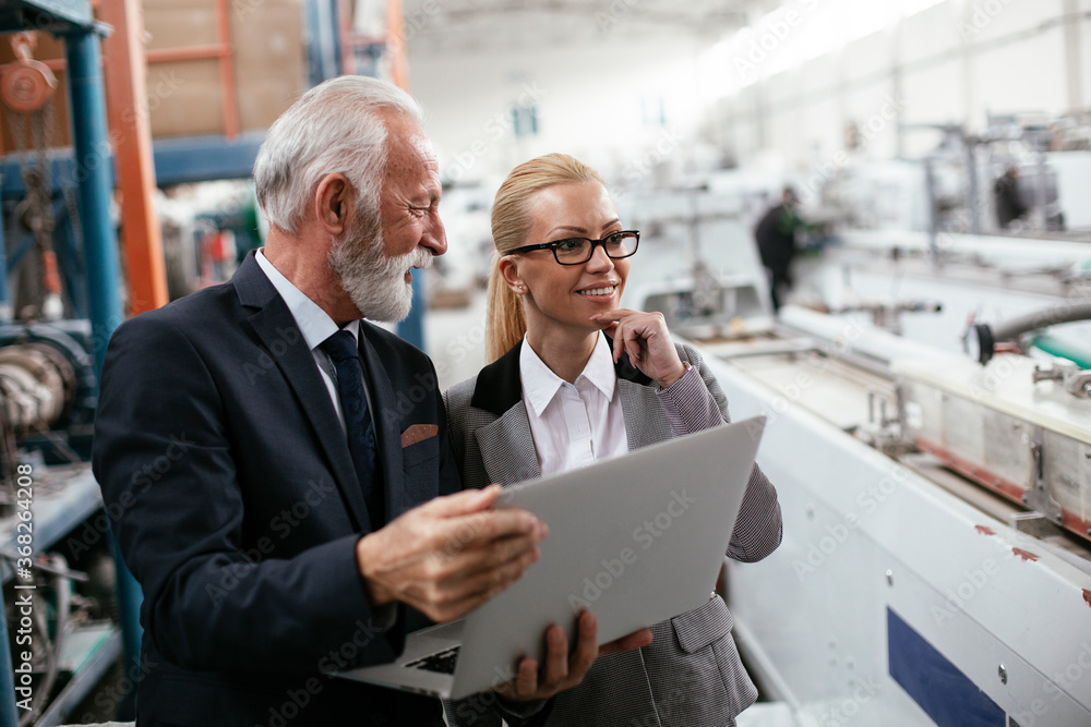 Man and woman discussing work. Colleagues working in factory.. Man and woman discussing work. Colleagues working in factory..