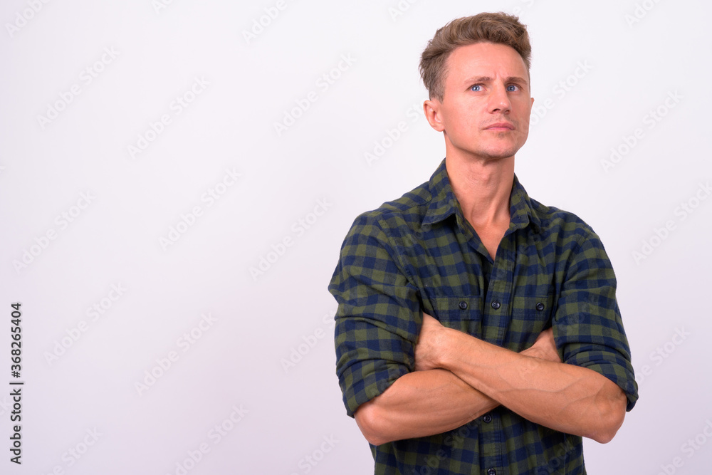 Handsome man with blond curly hair against white background