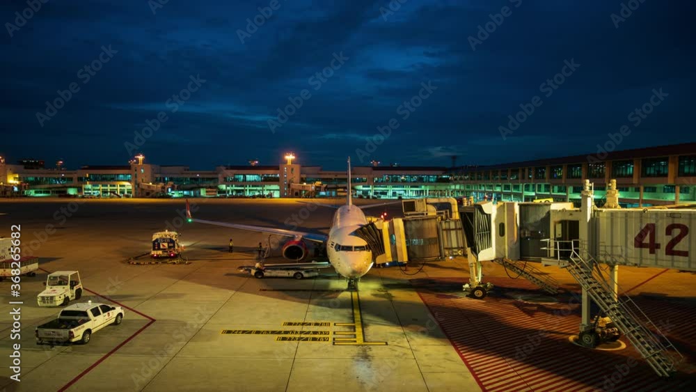 custom made wallpaper toronto digitalTime lapse ground staff Preparing the aircraft before flight Loading of baggage Food for flight services and equipment before boarding the airplane at night time, 4K 3840 x 2160 resolutions.