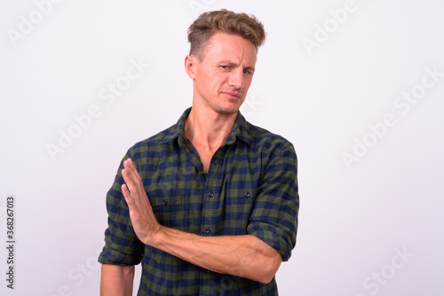 Handsome man with blond curly hair against white background