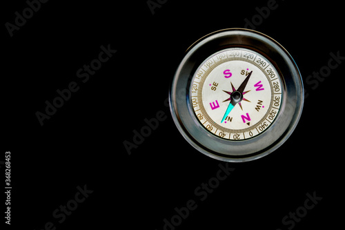 abstract round compass on black background as symbol of tourism with compass, travel with compass and outdoor activities with compass © yarbeer