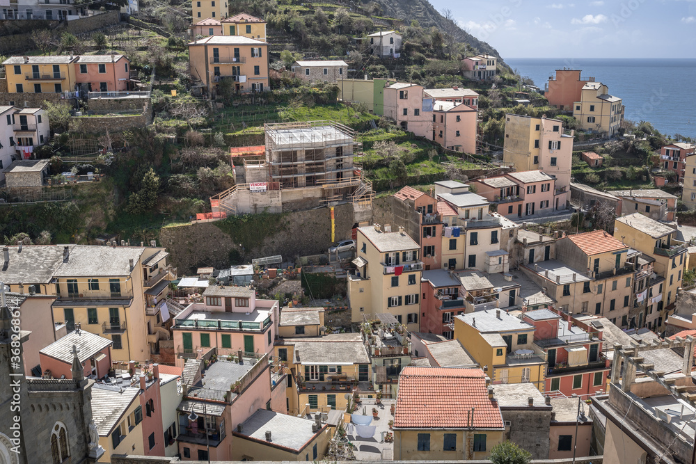 Riomaggiore village, first & most southern of Cinque Terre coastal villages, located in a small & narrow valley, as seen from east towards the Mediterranean sea, La Spezia, Liguria region, Italy.