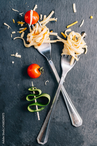 
Pair of forks with rolled spaghetti, cherry tomatoes and zucchini
Conceptual of healthy food, new trend veganism